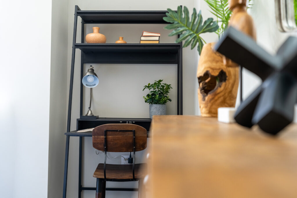 A cozy nook used for an office with a desk and chair at The Hive apartment in City Center Allentown.