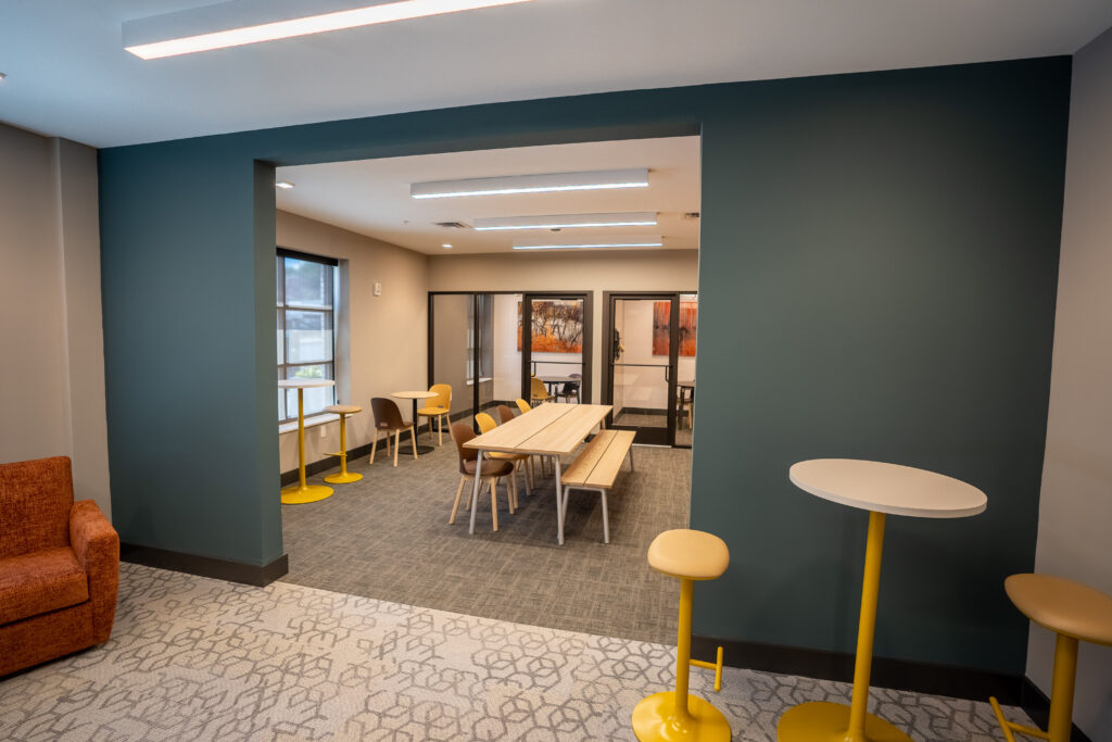 A shared collaborative co-working space with two private conference rooms and huddle rooms at The Hive.
